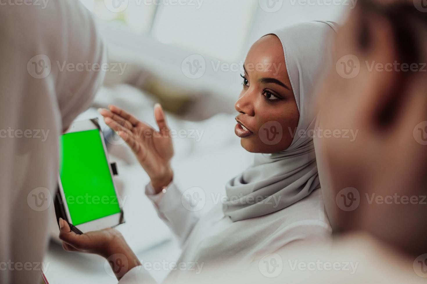 Group of happy african students having conversation and team meeting working together on homework girls wearing traidiional sudan muslim hijab fashion photo