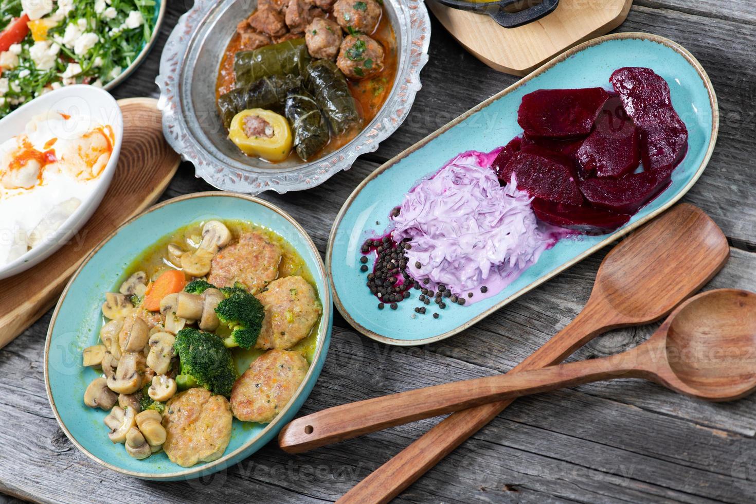 Eid Mubarak Traditional Ramadan Iftar dinner. Assorted tasty food in authentic rustic dishes on wooden table background. photo