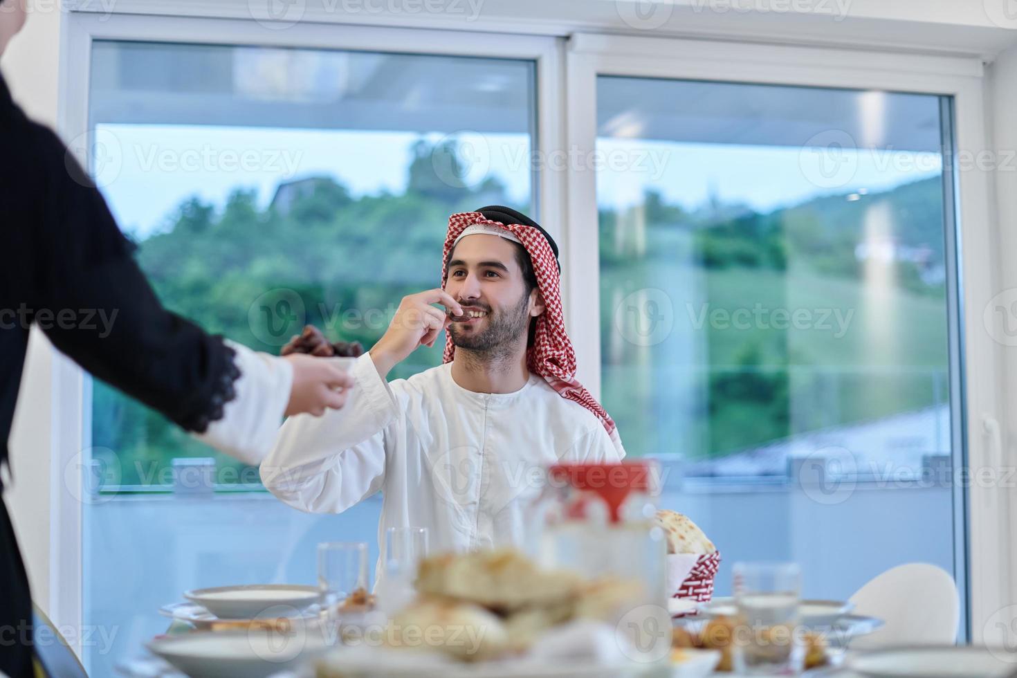 Muslim couple sharing dates for starting iftar photo