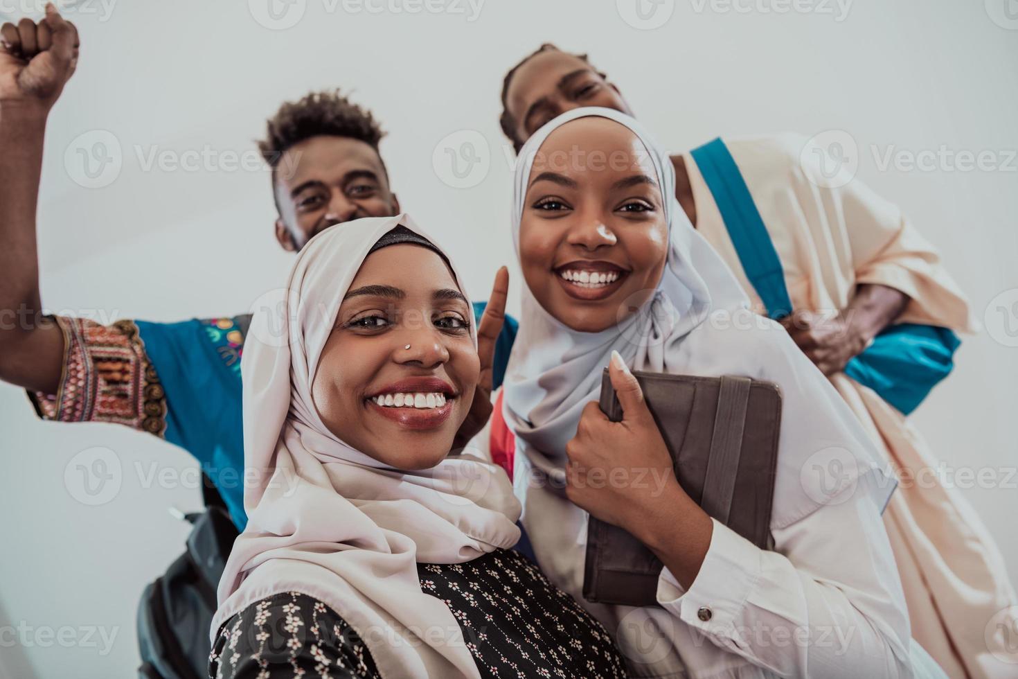 A group of multiethnic students take a selfie with a smartphone on a white background. Selective focus photo