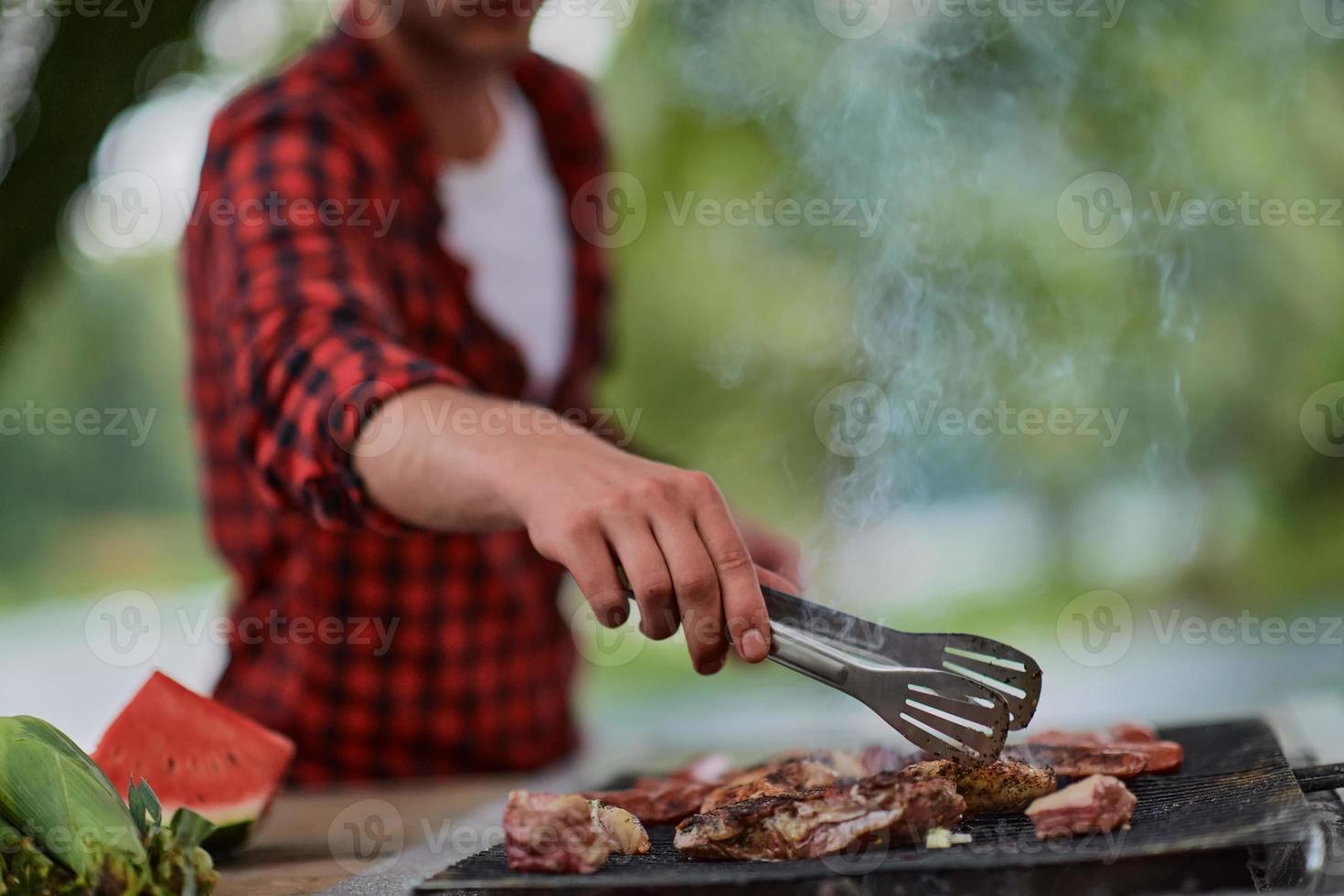 man cooking tasty food for french dinner party photo