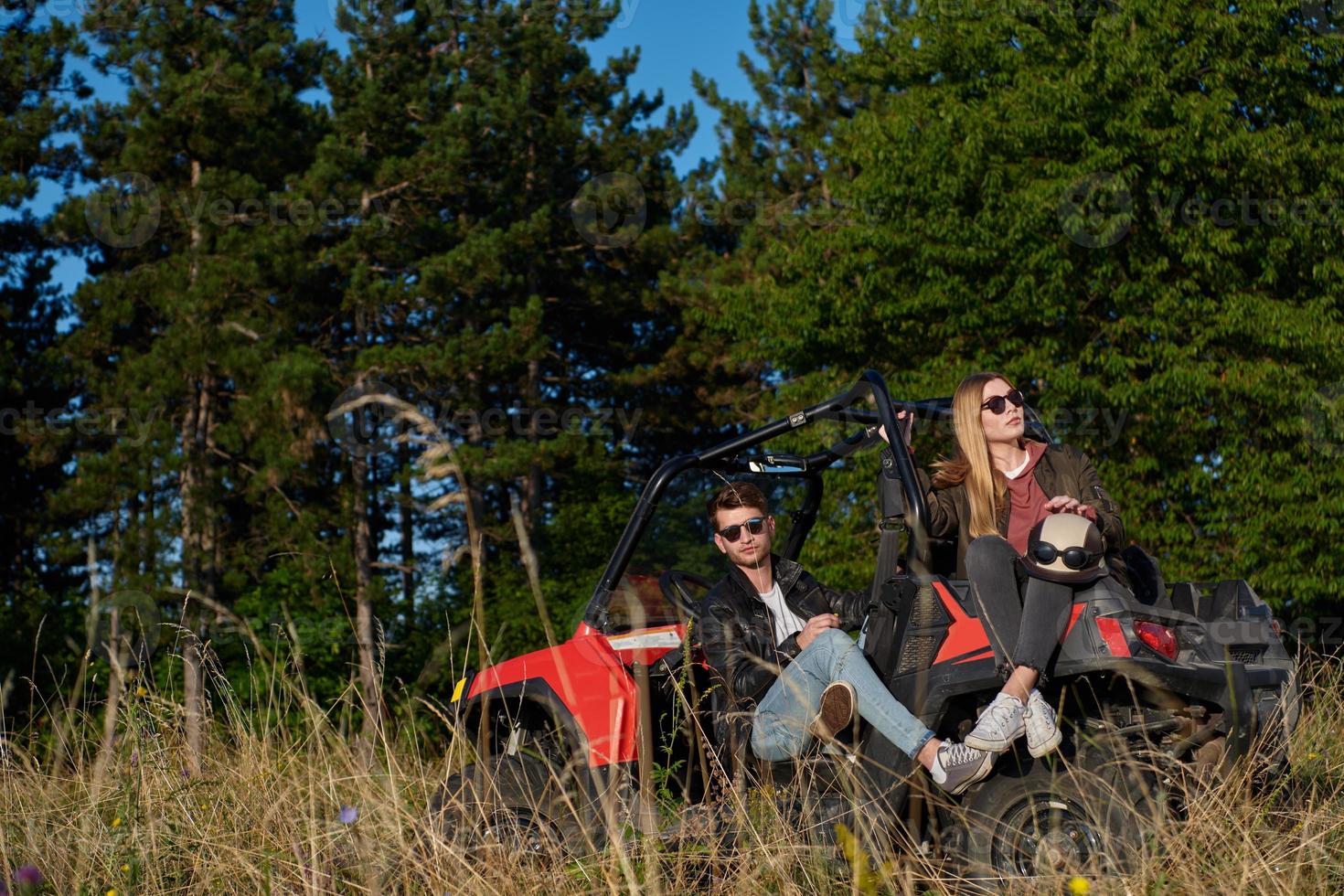 couple enjoying beautiful sunny day while driving a off road buggy photo