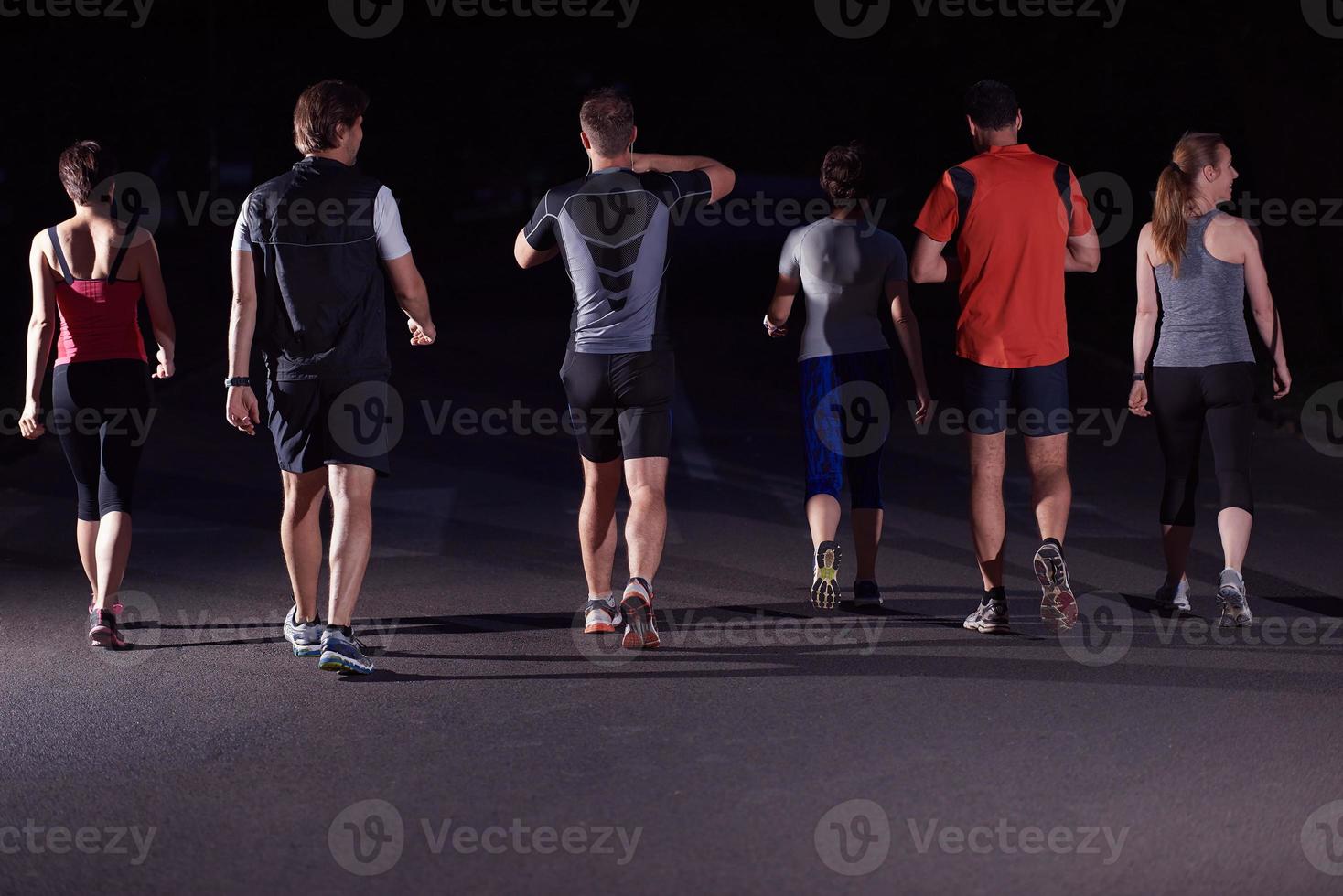 people group jogging at night photo