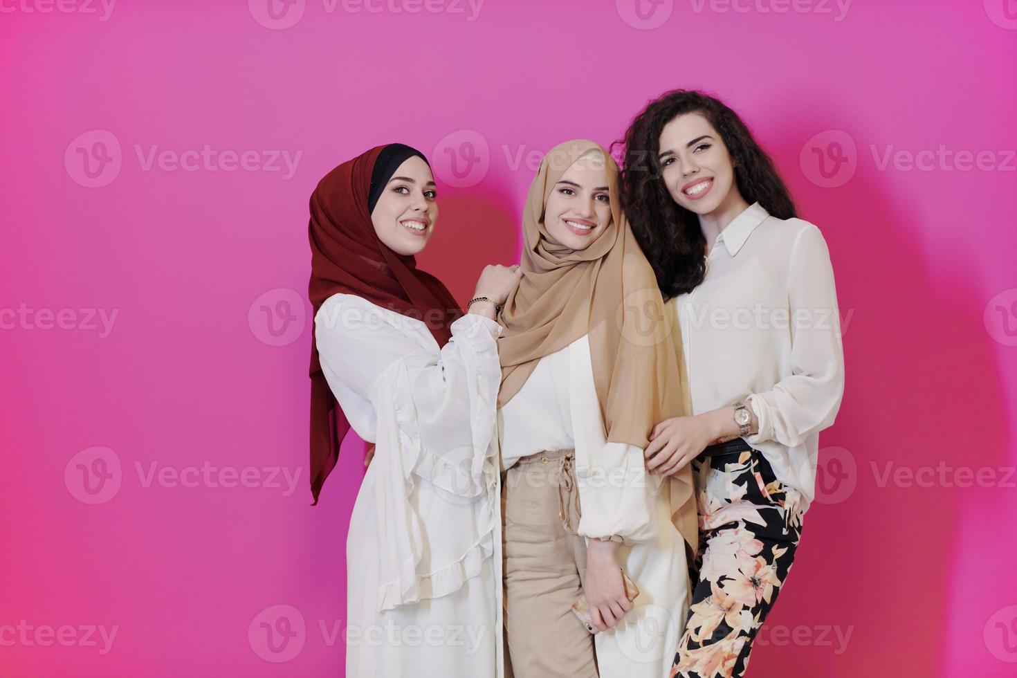 muslim women in fashionable dress isolated on pink photo