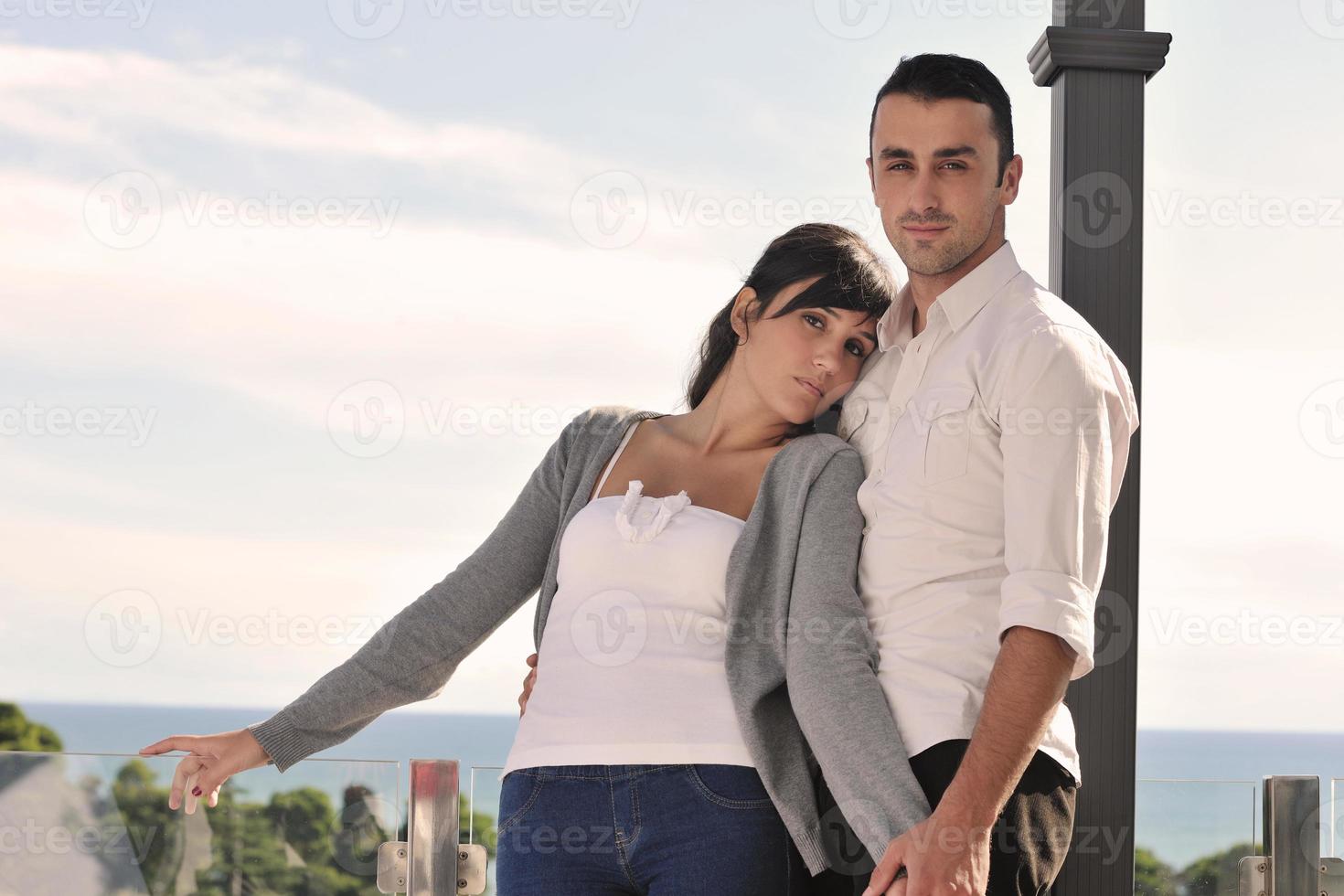 couple relaxing on balcony photo