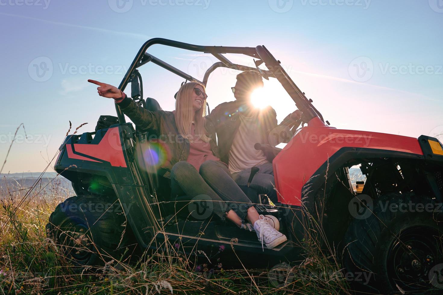 couple enjoying beautiful sunny day while driving a off road buggy photo