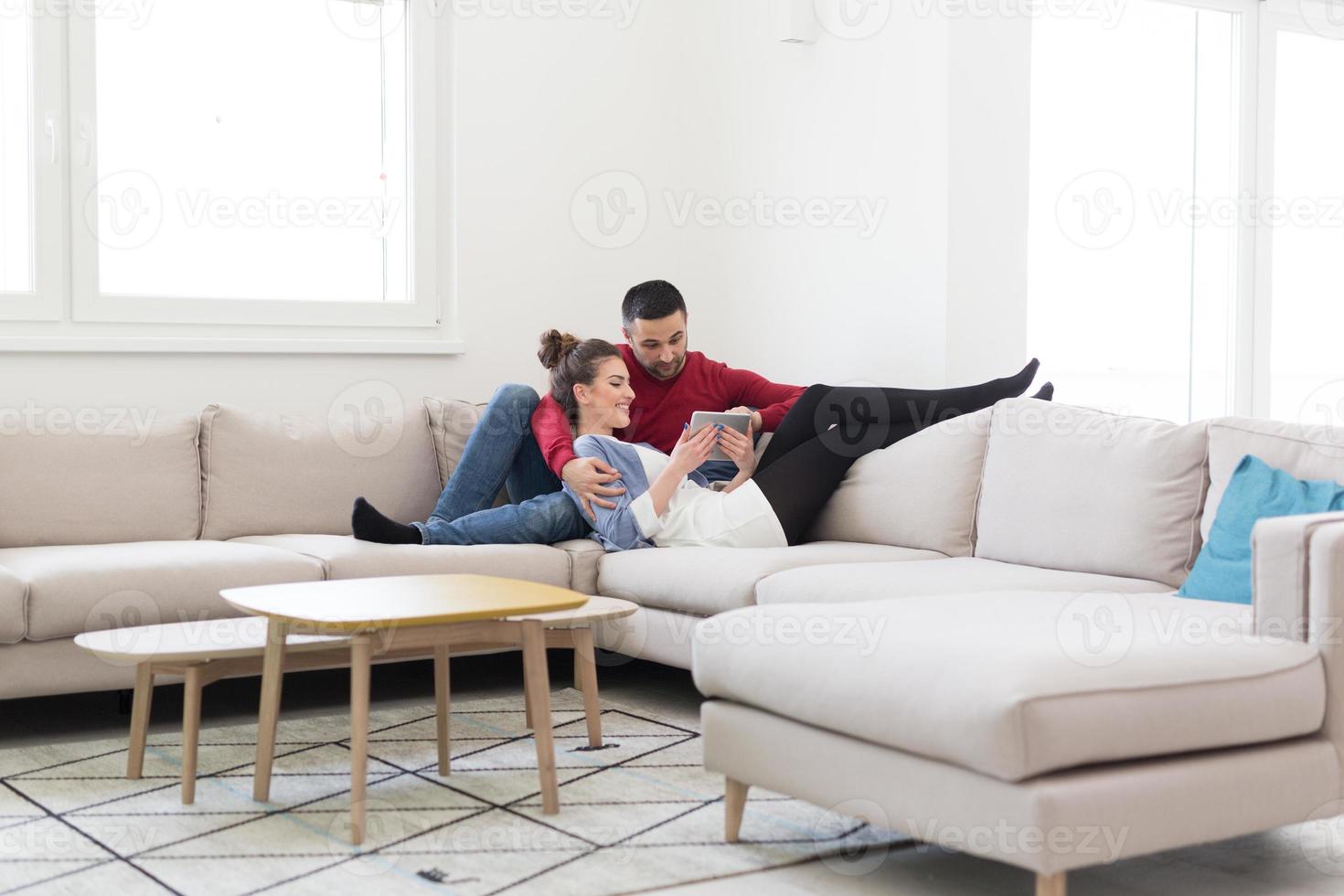 couple relaxing at  home with tablet computers photo