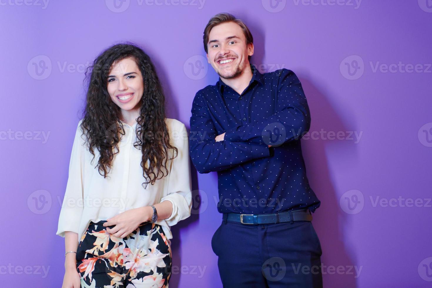 portrait of young couple isolated over purple background photo