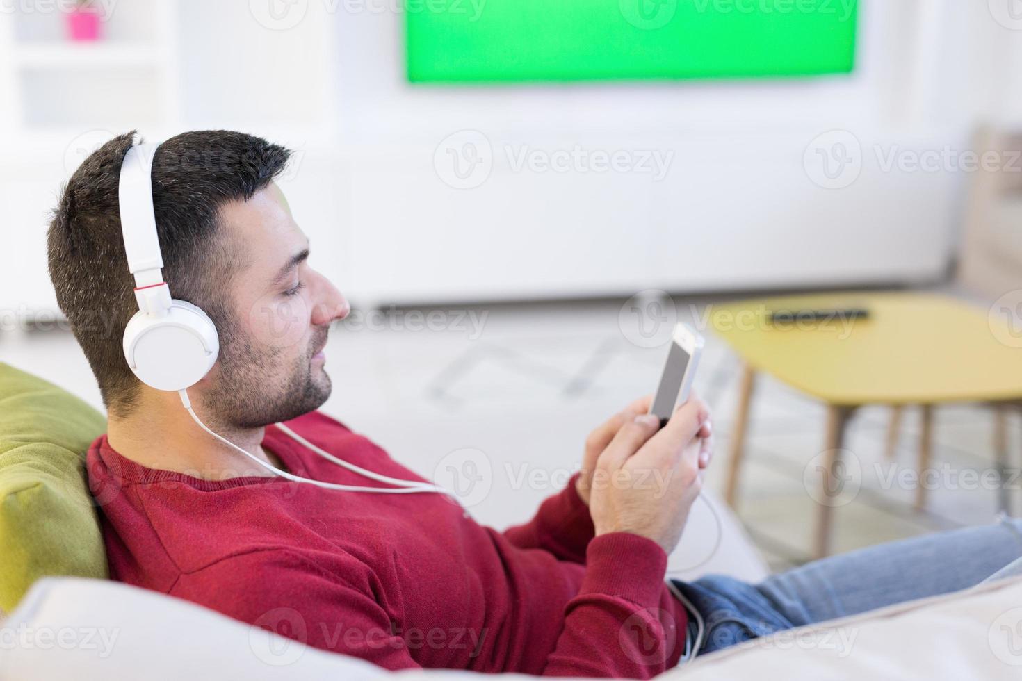 man enjoying music through headphones photo