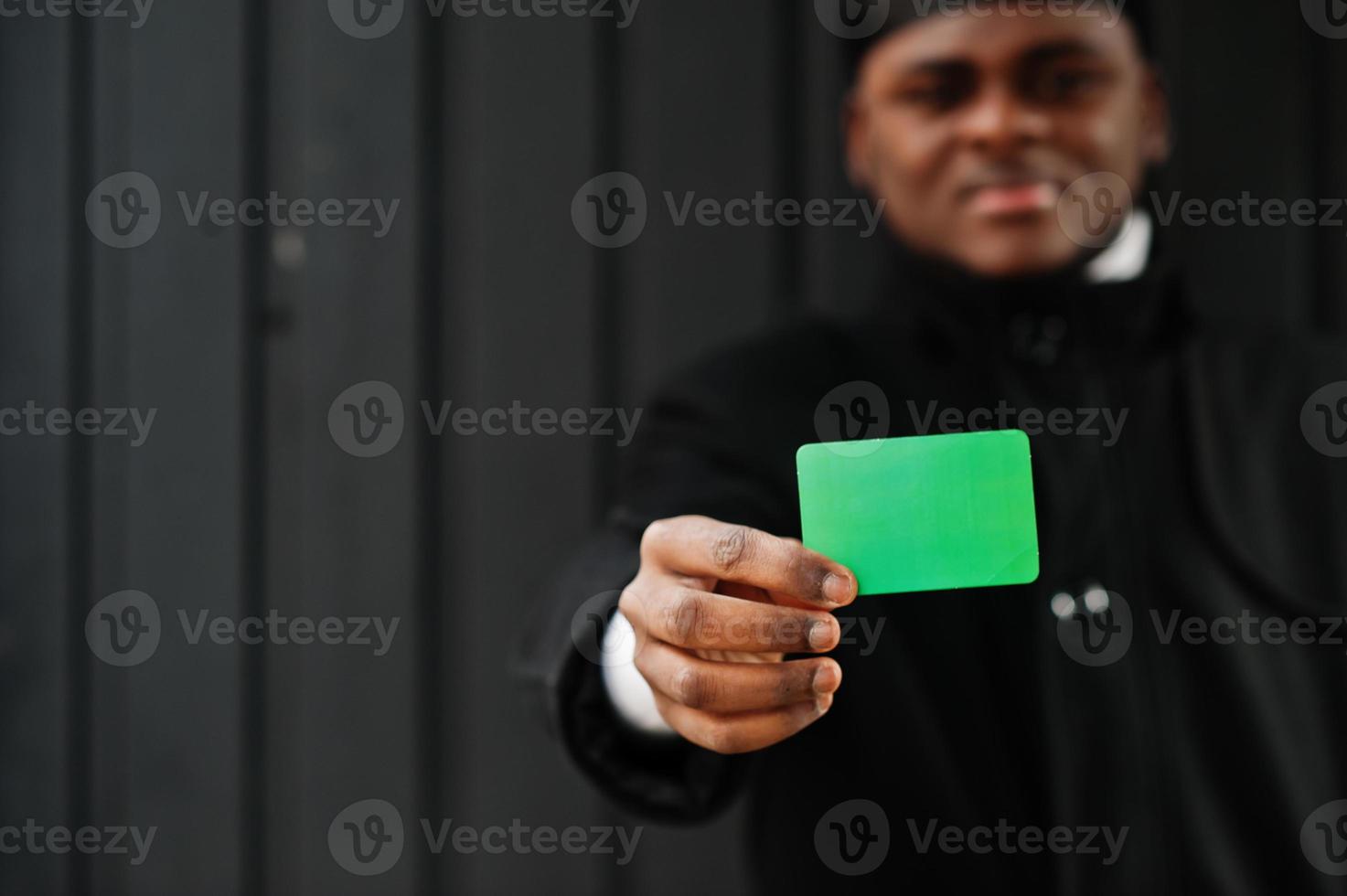 African man wear black durag hold Libya flag at hand isolated dark background. photo