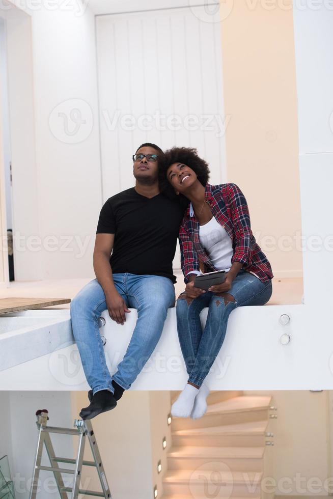 couple having break during moving to new house photo