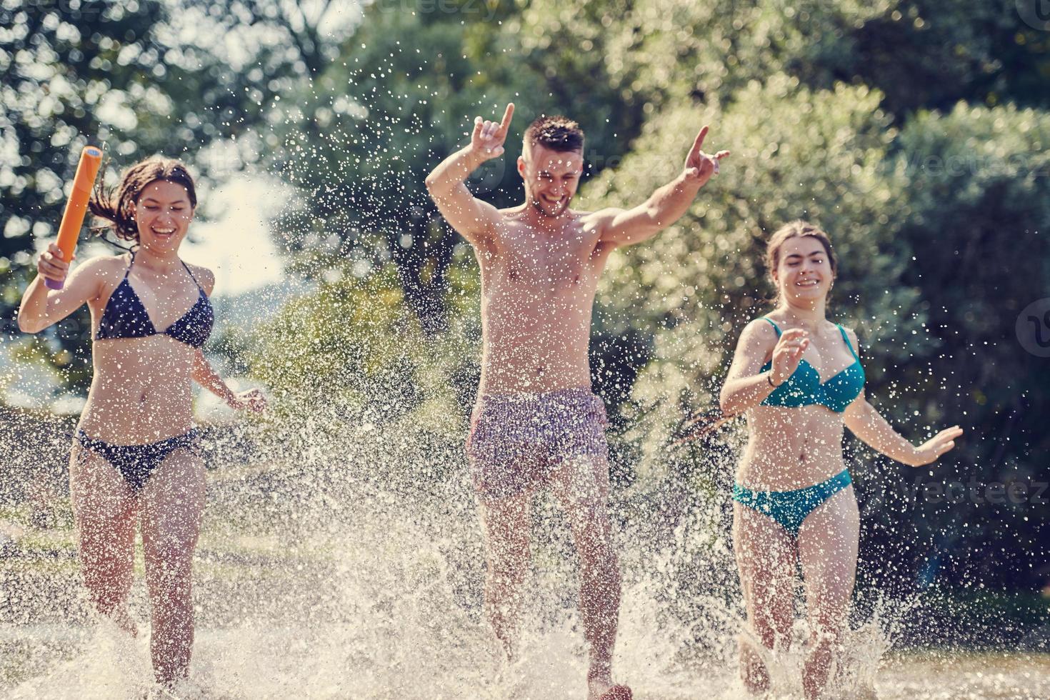 group of happy friends having fun on river photo