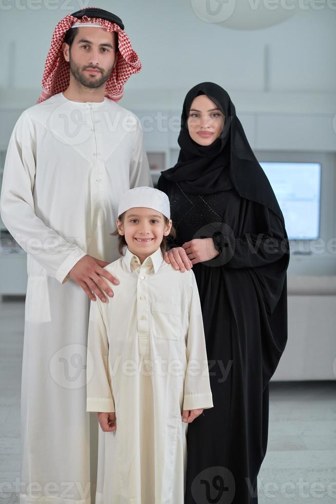 Portrait of young arabian muslim family wearing traditional clothes photo