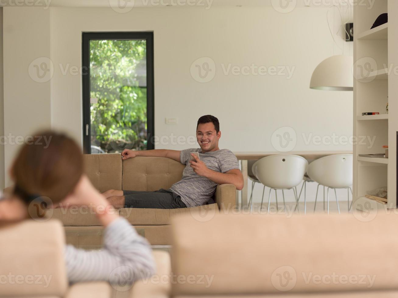 young man using a mobile phone  at home photo