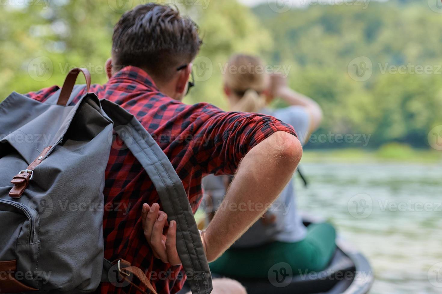 friends are canoeing in a wild river photo