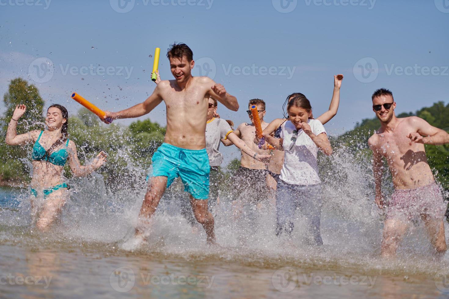 group of happy friends having fun on river photo