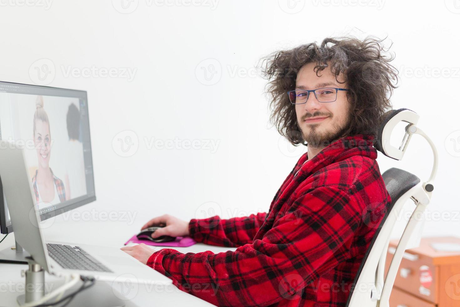graphic designer in bathrobe working at home photo
