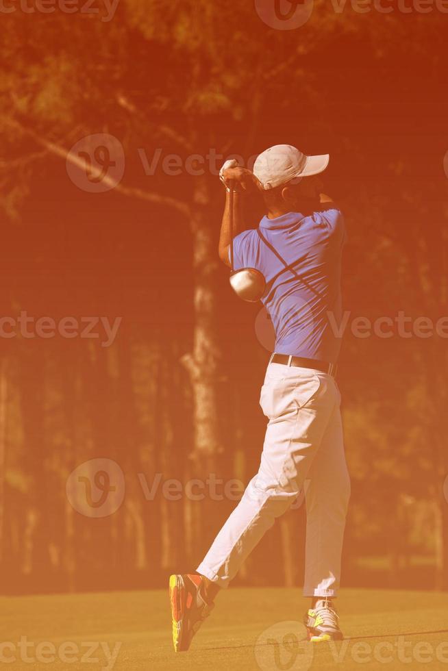 golf player hitting long shot photo