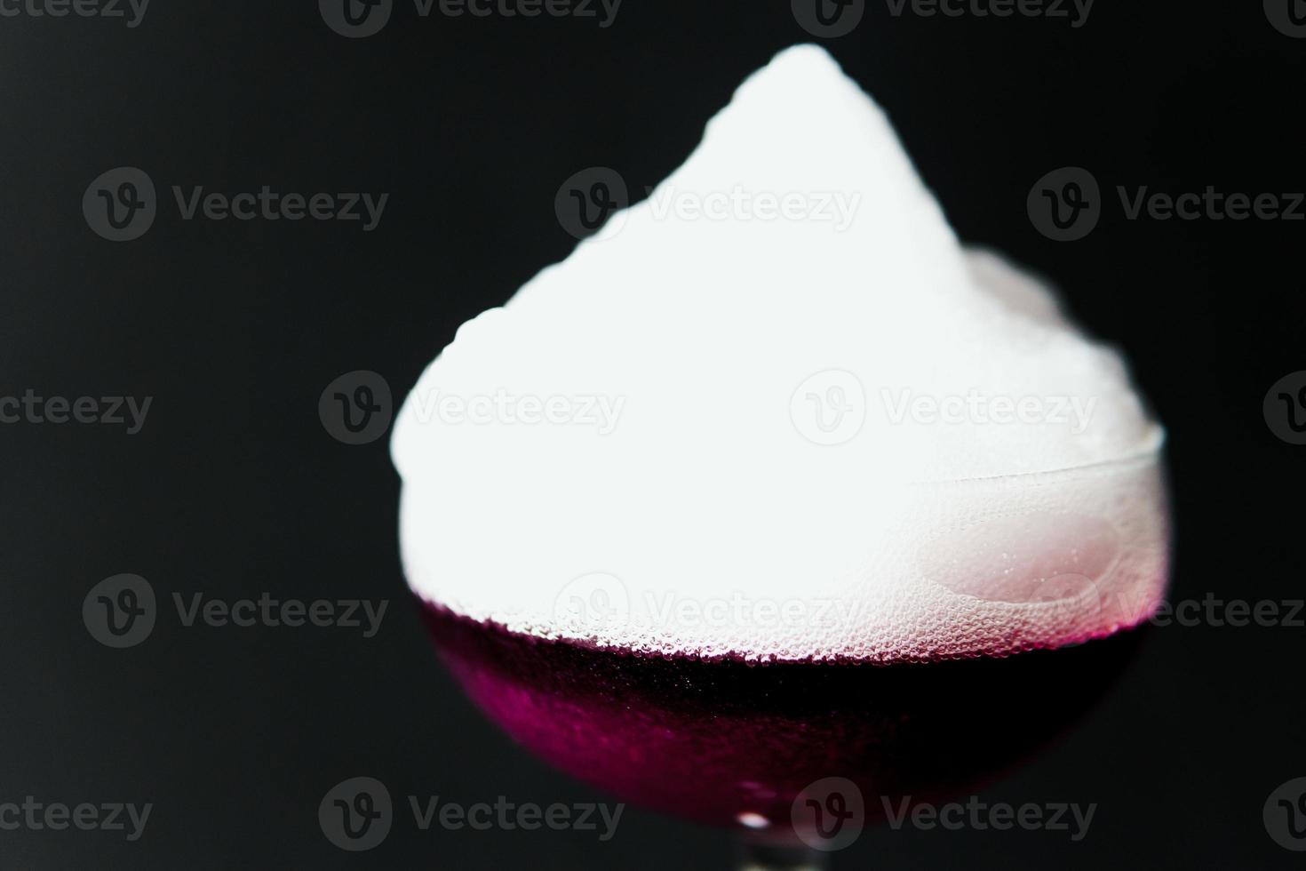 Alcoholic drink. A cocktail with elite alcohol on dark black background, close-up. photo