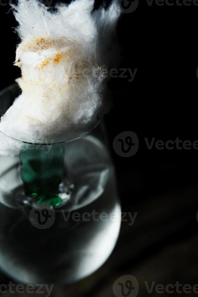 Alcoholic drink. A cocktail with elite alcohol on dark black background, close-up. photo