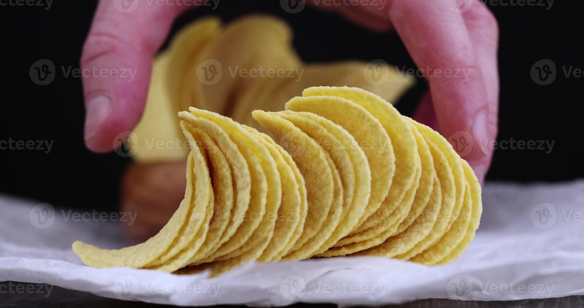 Take crispy potato chips fried together with spices photo