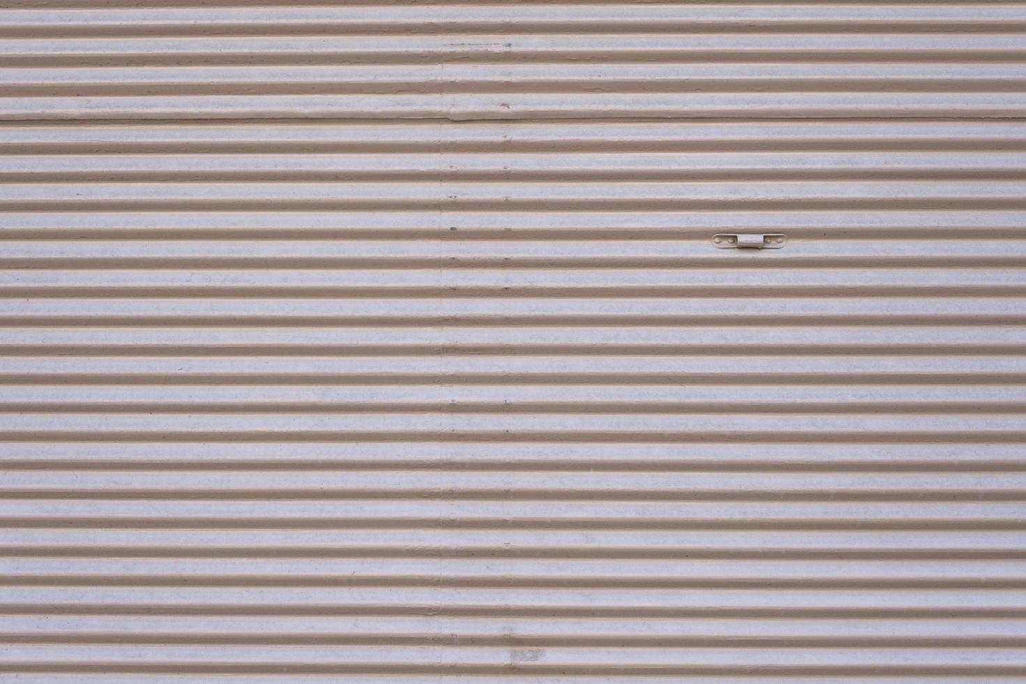 Grey vintage striped door, closeup of garage steel wall texture, horizontal lines pattern, background. photo