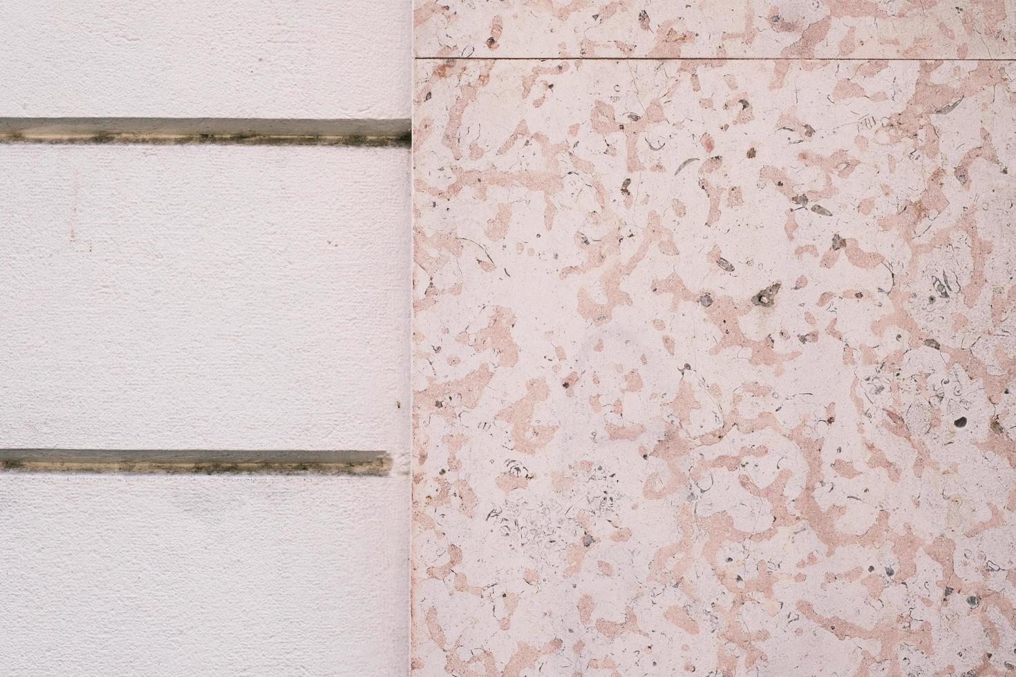Decorative marble stone tile wall, texture, dirty and aged building facade surface, outside architecture decoration details, background. photo