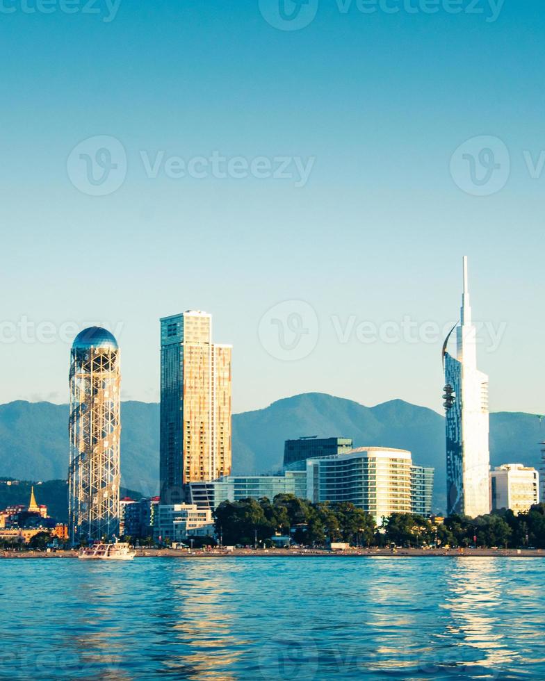 Panoramic View to Batumi coast and tourist attractions with romantic sunset in the background. Vacation holidays in caucasus. Georgian vegas. photo