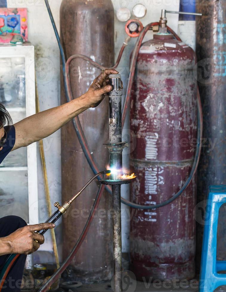 Welders were repairing cutting Shock absorbers photo