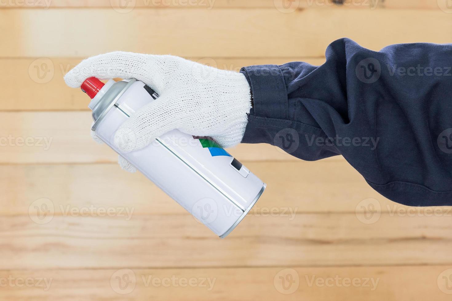 Hand holding spray paint can photo