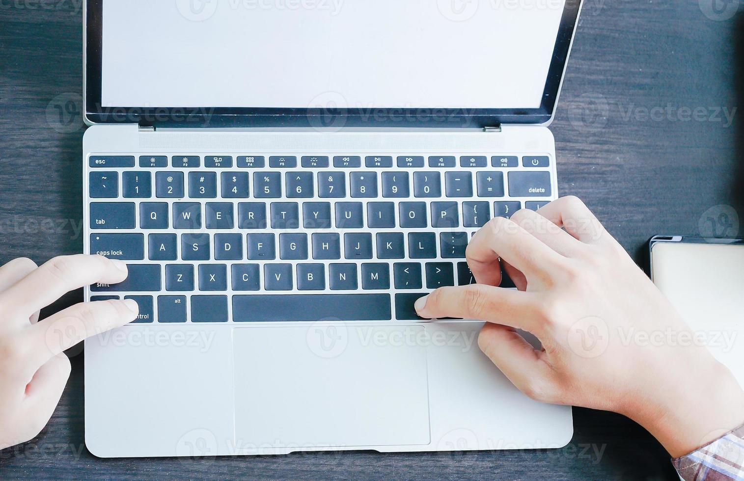 Male working with Laptop computer on the table photo