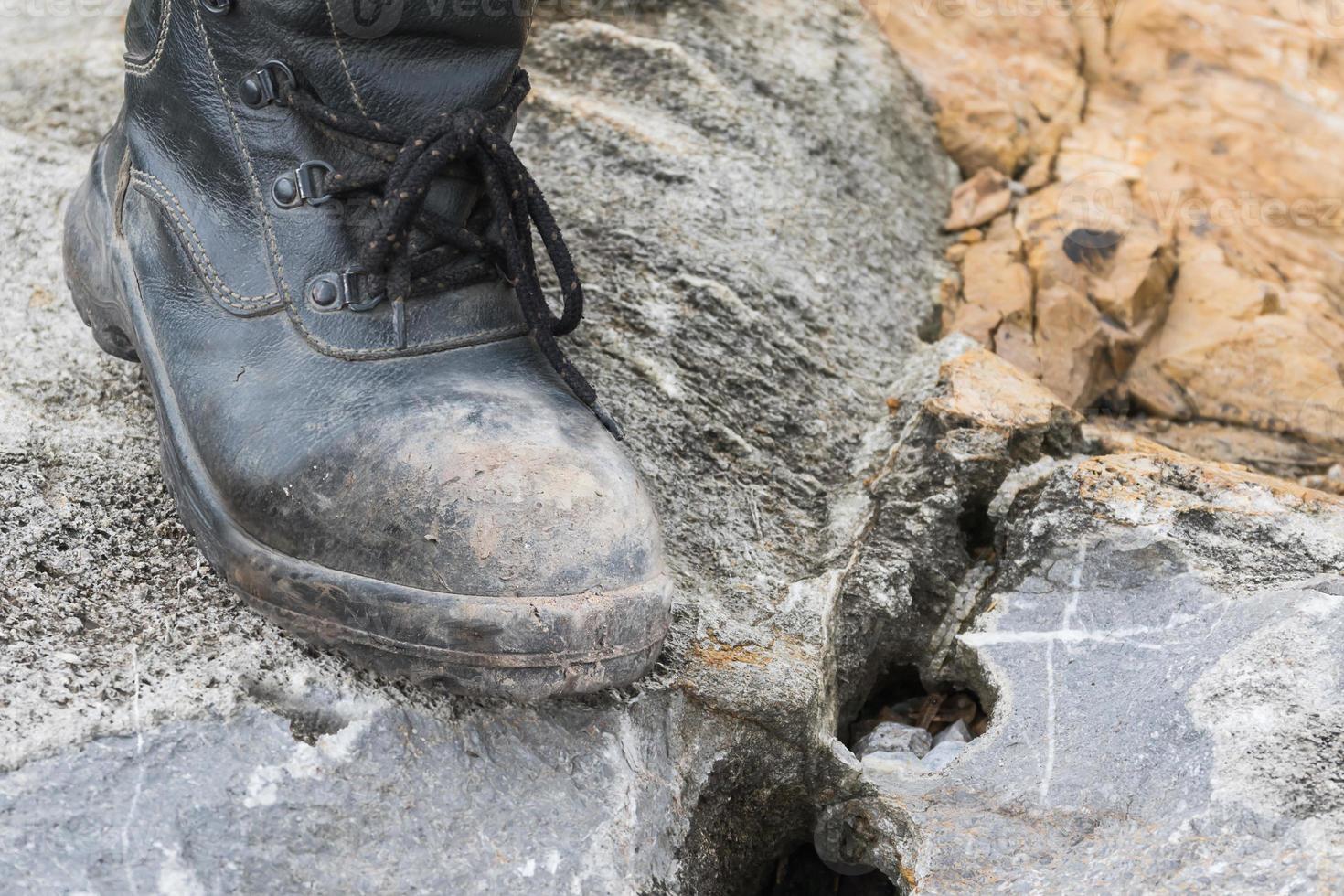 Trekking leather boot on the rock photo