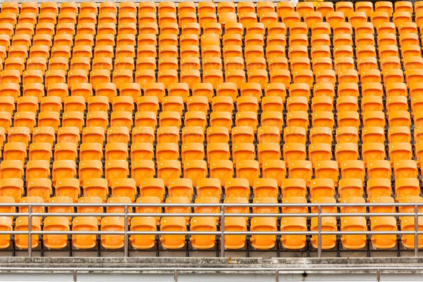 Rows of empty plastic stadium seats photo