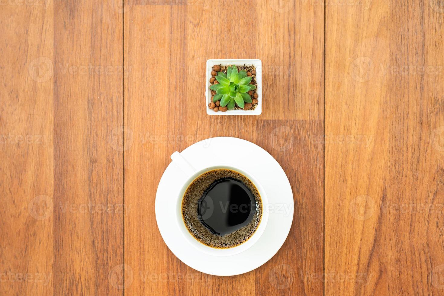 White cup of coffee on wood background photo