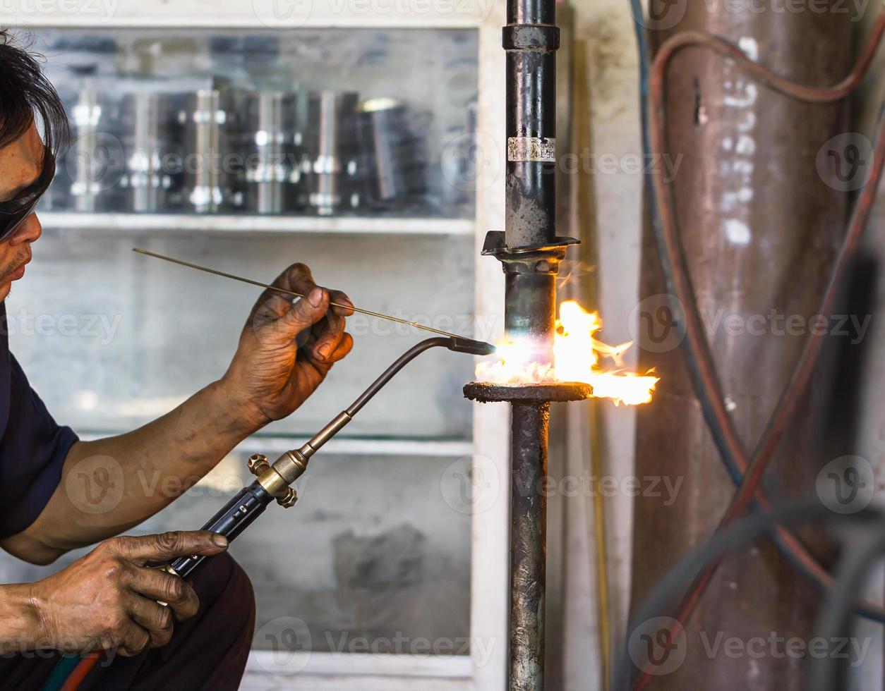 Welders were repairing cutting Shock absorbers photo