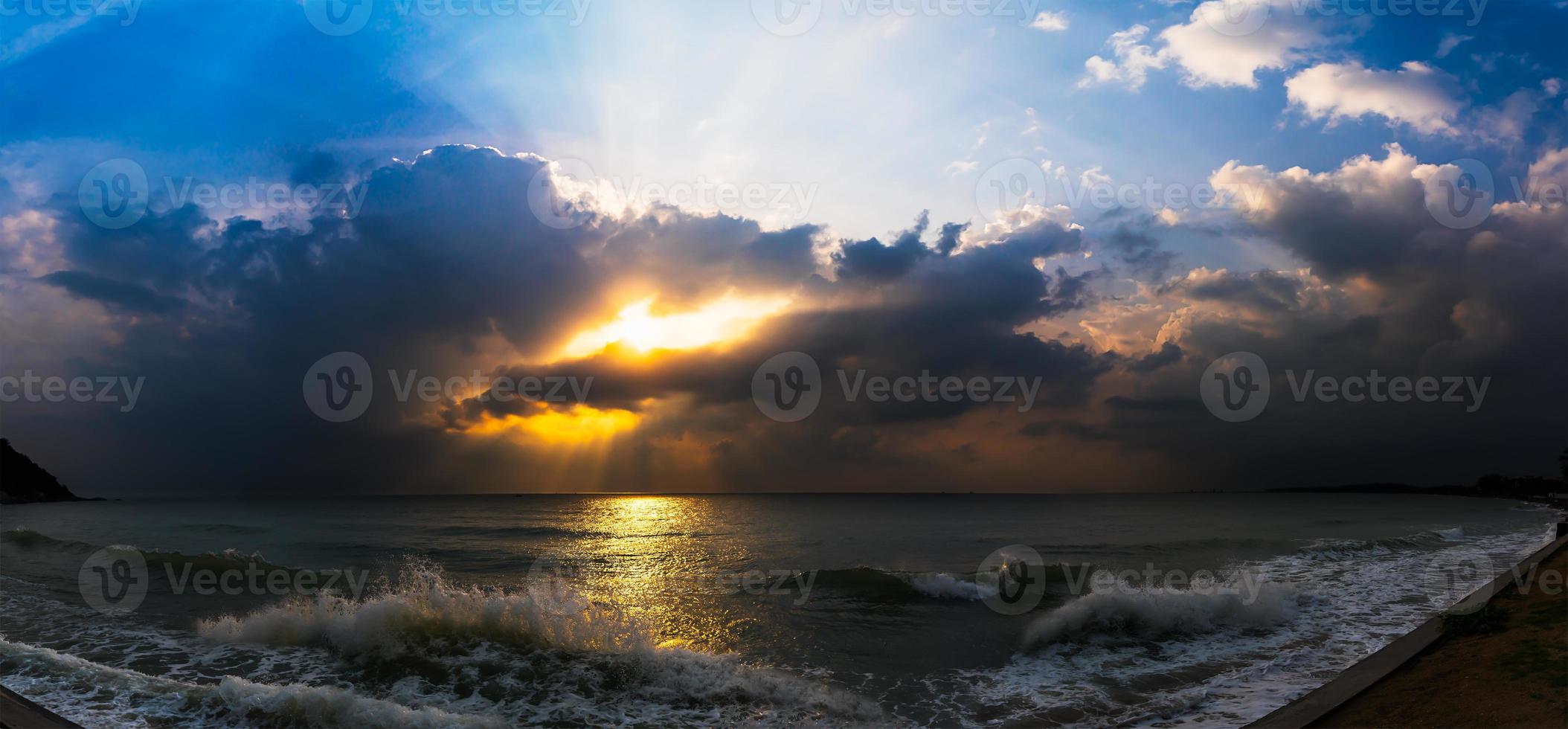 Sunset with dramatic cloud over sea photo