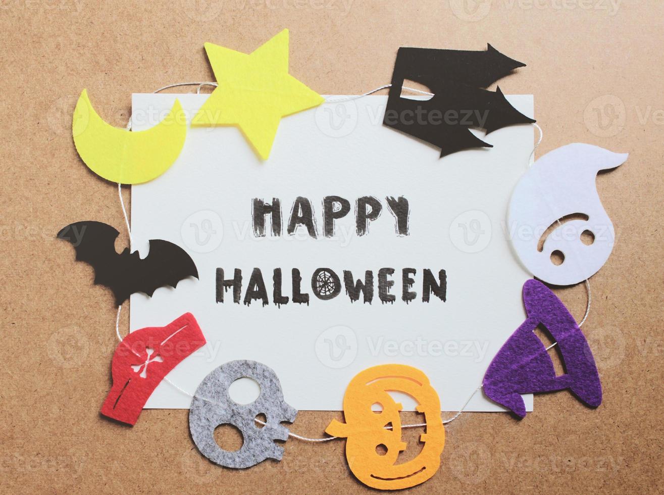 Happy halloween written on paper with halloween ornament for frame photo