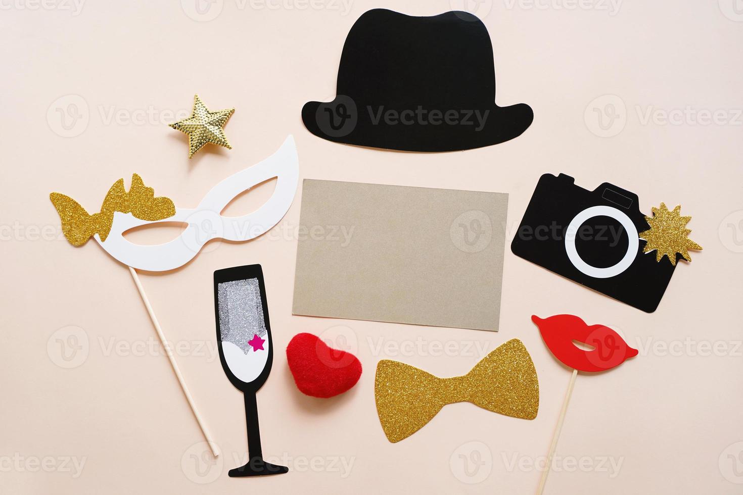 Cute party props with blank card on yellow background. Birthday, wedding party celebration photo