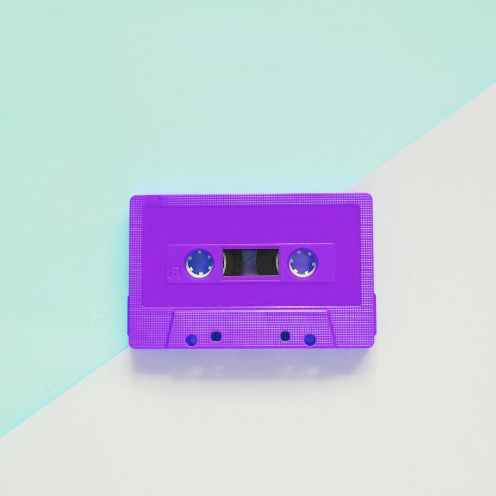 Flat lay retro colorful cassette tape on pastel color background, minimal style photo