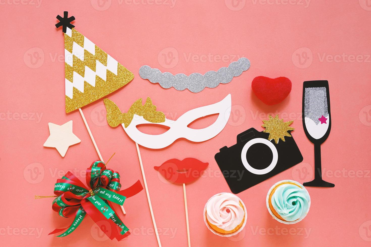 Cute party props and cake on colorful background, happy new year party celebration photo