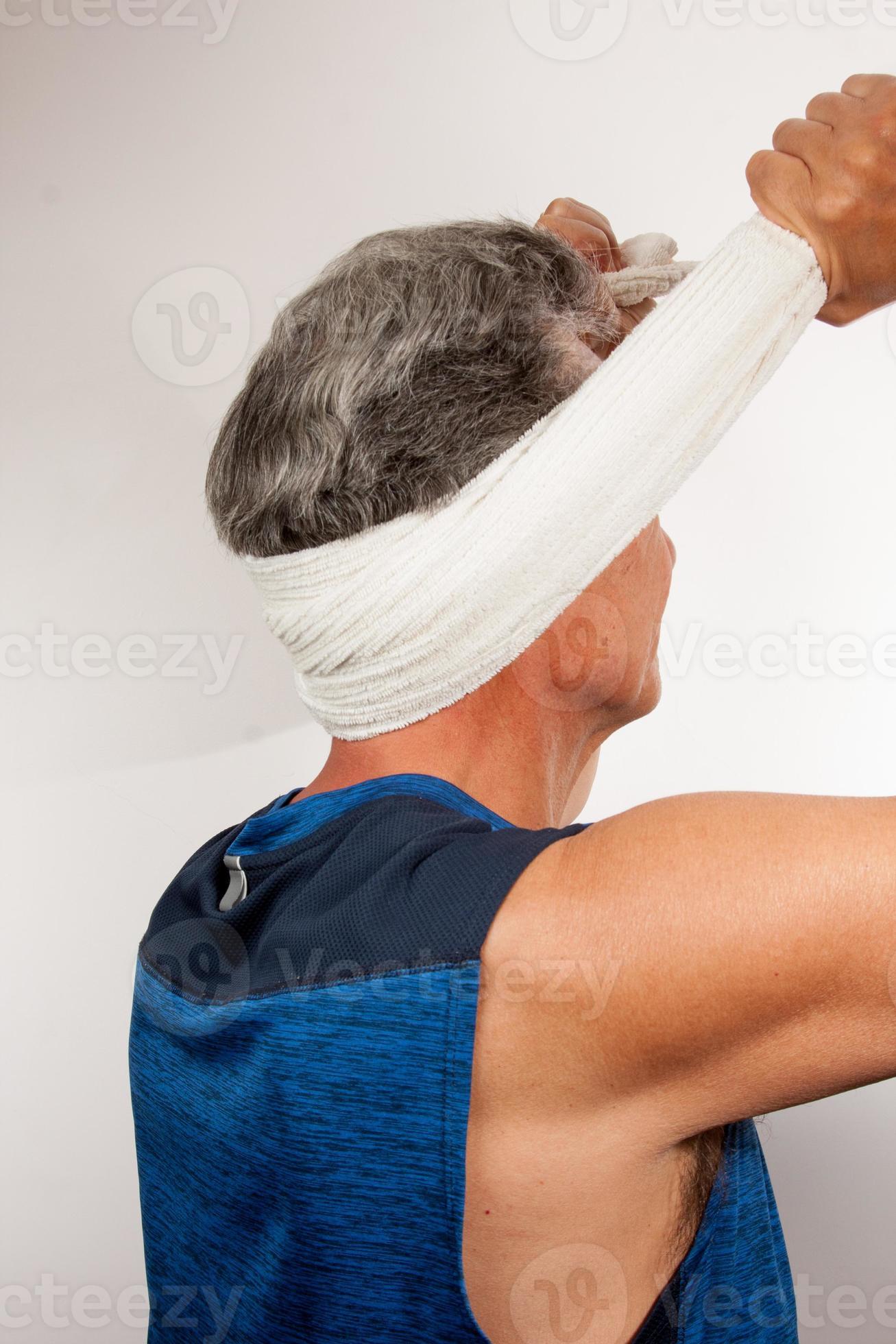 https://static.vecteezy.com/system/resources/previews/010/970/809/large_2x/mature-man-60plus-stretching-out-his-neck-for-pain-relief-with-a-towel-photo.jpg