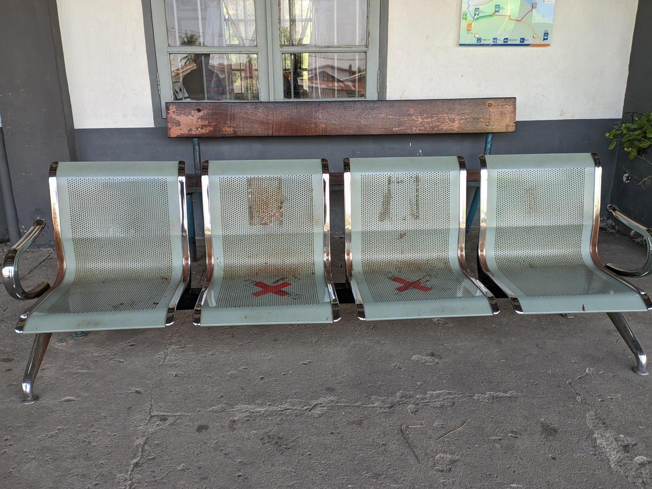 stainless steel waiting bench in front of the train station which is used to wait for trains or relatives photo