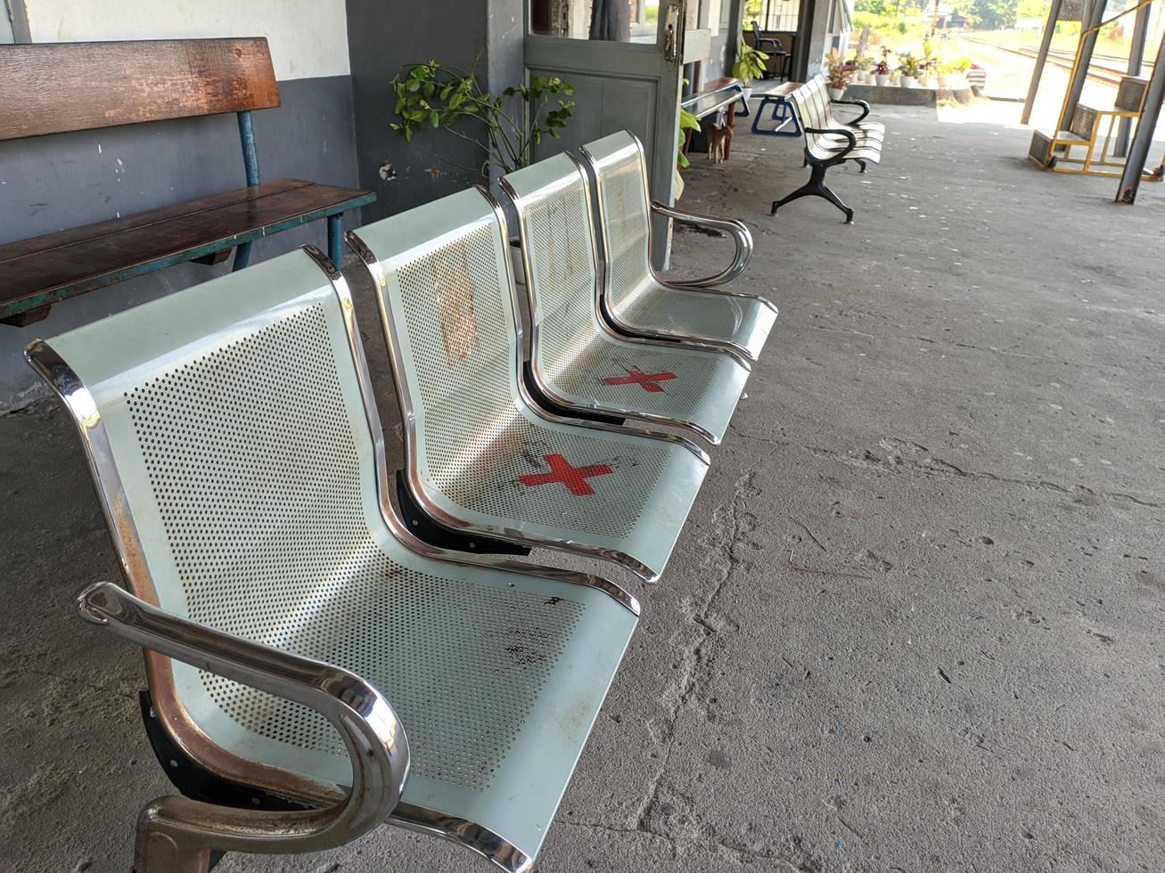 stainless steel waiting bench in front of the train station which is used to wait for trains or relatives photo