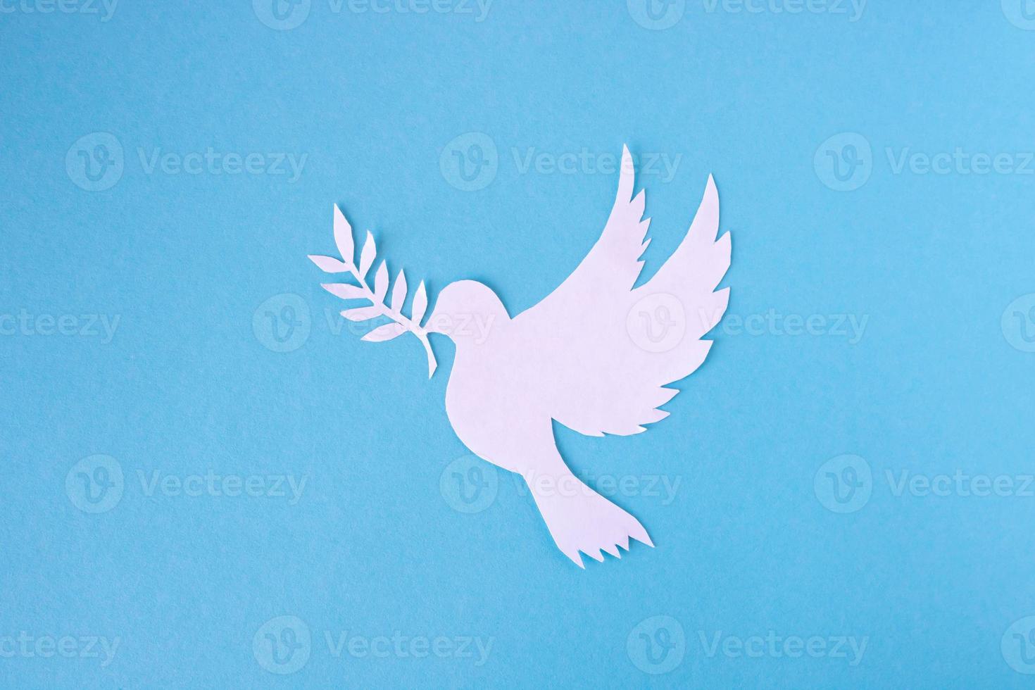 A white dove cut out of paper for the background of the World Peace Day. World Science Day for Peace and Development photo