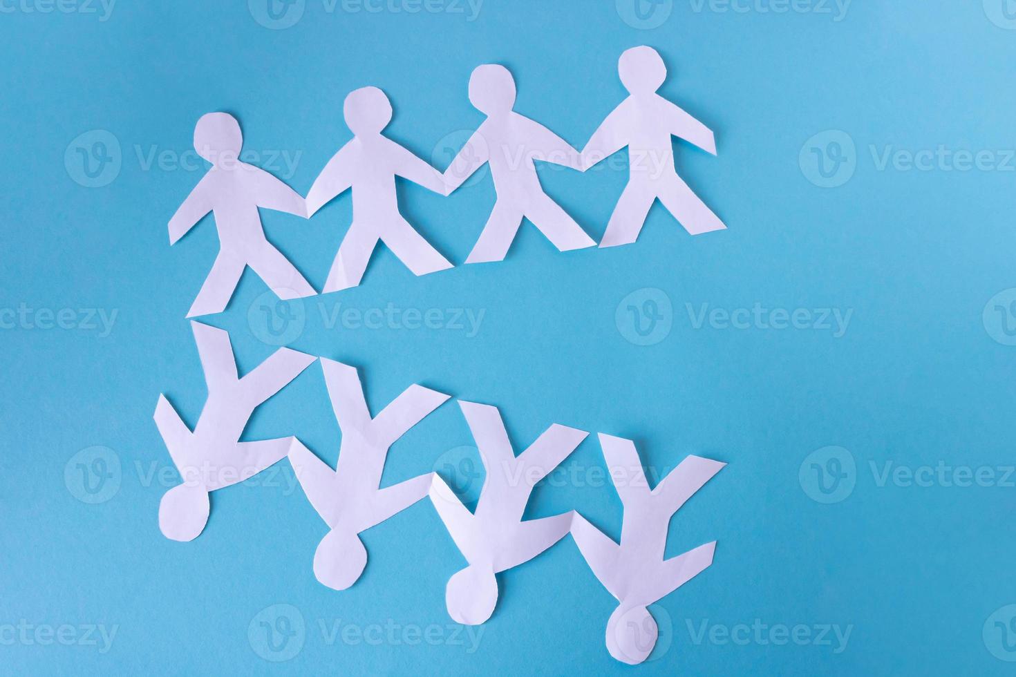 People cut out of paper on a blue background. The concept of the World Peace Day photo