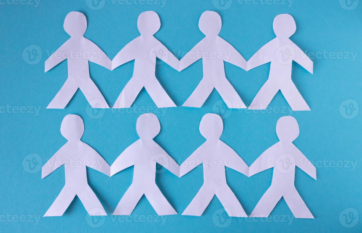 People cut out of paper on a blue background. The concept of the World Peace Day photo