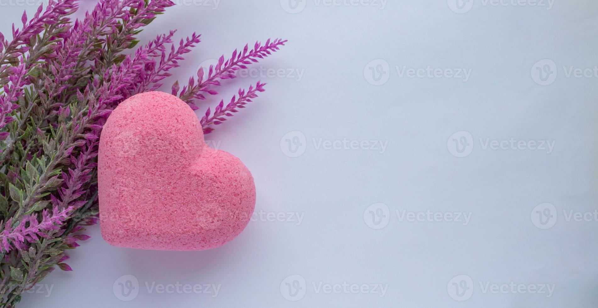 Purple heart bath salt and a branch of artificial lavender on a white background. Space for text photo