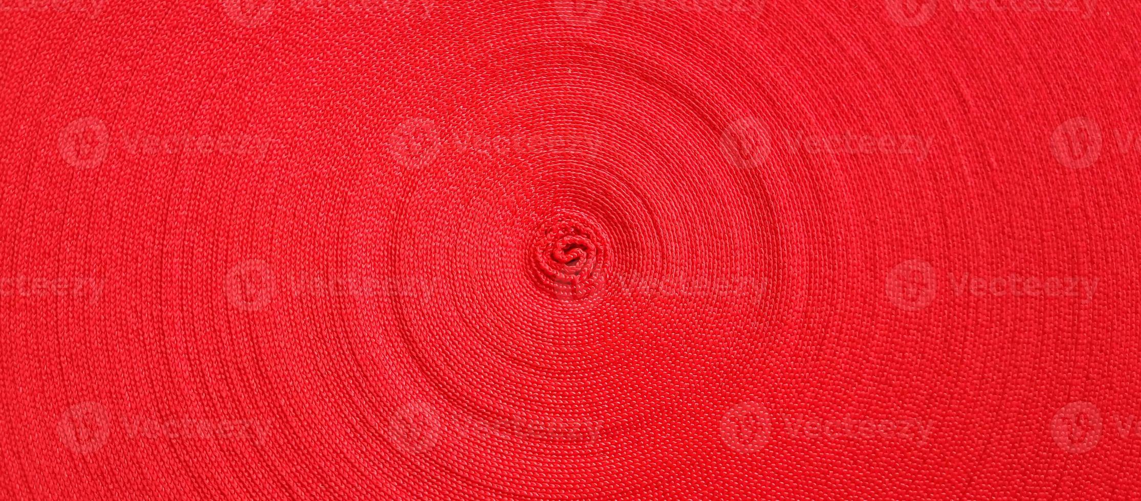 Red abstract circular pattern made of red sling photo