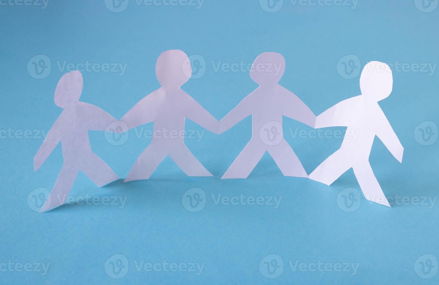 People cut out of paper on a blue background. The concept of the World Peace Day photo