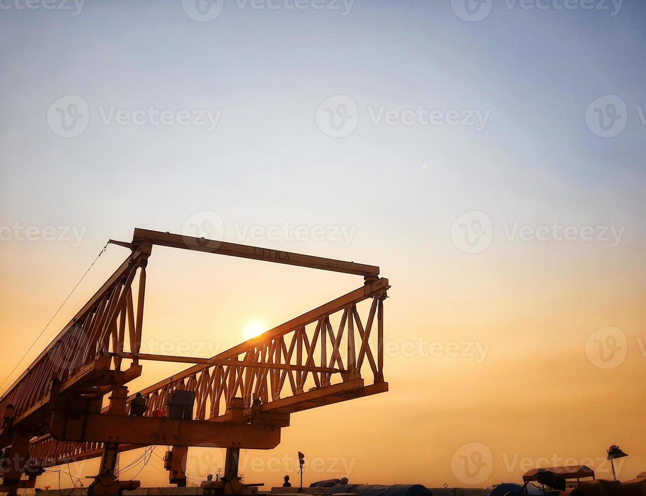 This is the steel structure of a launcher gantry on sunset that will be used for erection precast concrete I Girder PCI Girder. photo